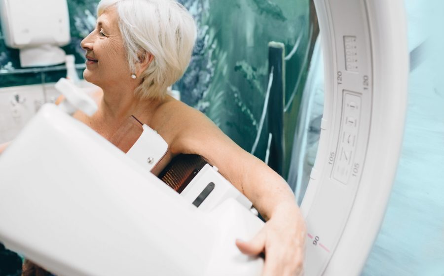 Mulher idosa fazendo uma mamografia no hospital