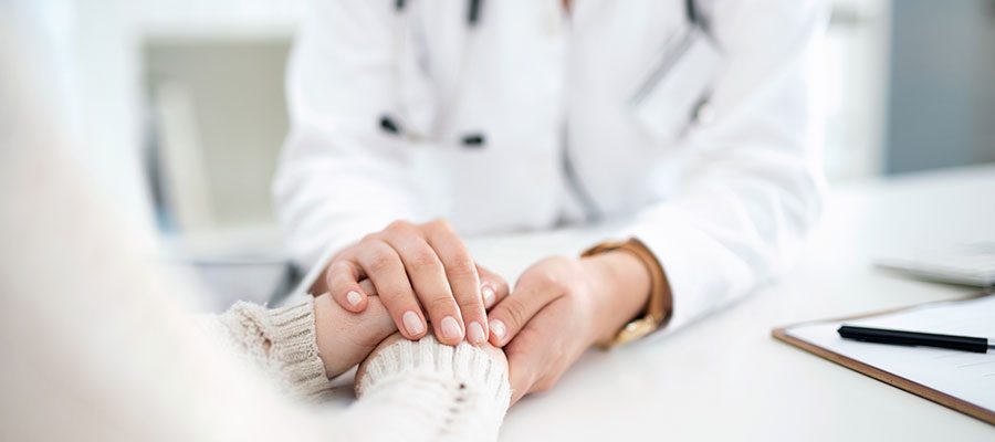 Médica fornecendo compaixão em tempos difíceis à paciente